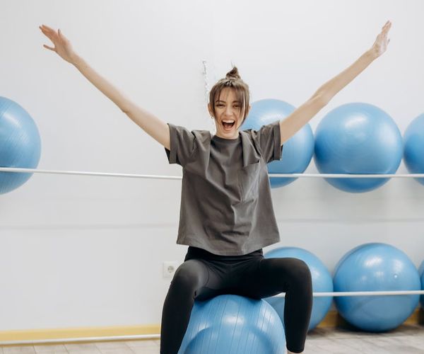 Woman smiling and stretching, feeling energetic and happy.